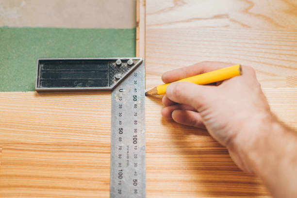 istock The carpenter marks the smooth cutting line on the board 1127785706