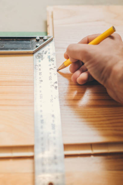 istock The carpenter marks the smooth cutting line on the board 1127785760