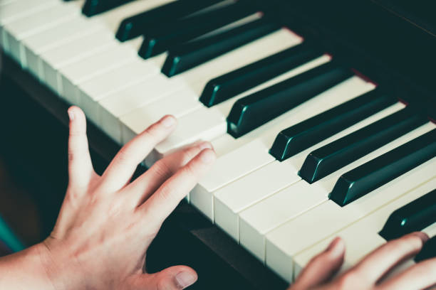 istock Close-up of a kid hand playing the piano 1127785844