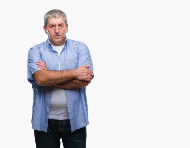 istock Handsome senior man over isolated background skeptic and nervous, disapproving expression on face with crossed arms. Negative person. 1127786542
