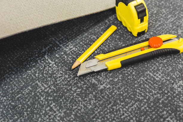 istock Work tools for laying carpet - tape measure, knife and pencil 1127787026