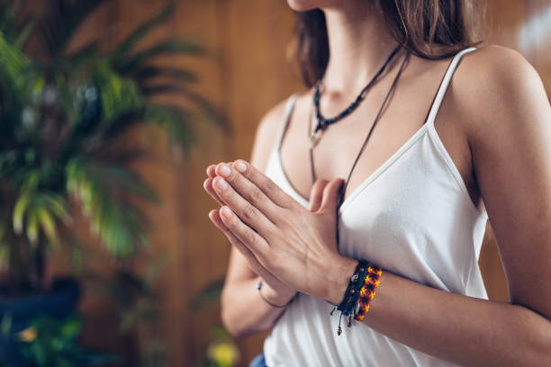 istock Midsection Of Young Woman Doing Yoga 1127787154