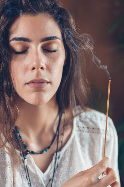 istock Young Woman Holding Burning Incense 1127787163