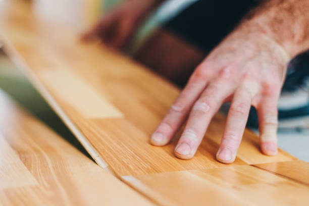 istock The master skillfully installs parquet - floor work during finishing 1127787283