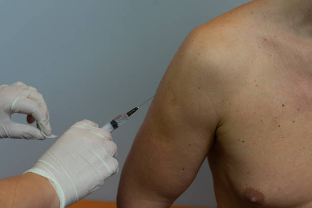istock Doctor give injection to patient's arm. Close up. 1127788936