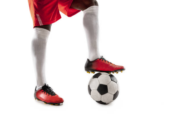 istock legs of soccer player close-up isolated on white 1127789277