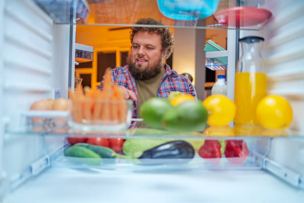 istock Man looking something to eat at night. 1127790186