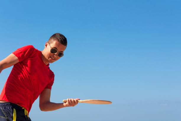 istock The guy plays matkot on the beach 1127791332