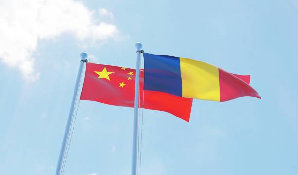 istock Romania and China, two flags waving against blue sky 1127791595