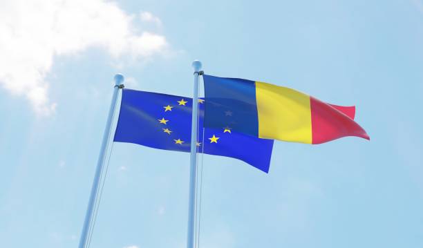 istock Romania and European Union, two flags waving against blue sky 1127792205