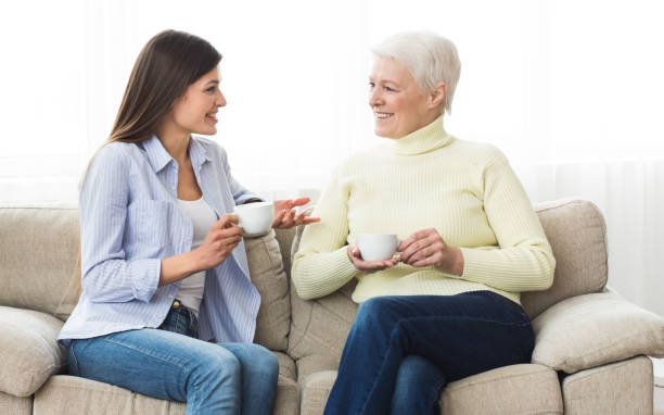 istock Senior mother and daughter drinking coffee and talking 1127792316