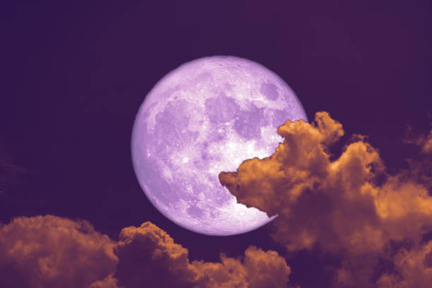 istock worm moon back on silhouette heap cloud on sunset sky 1127792598