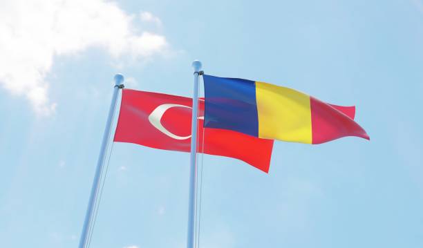istock Romania and Turkey, two flags waving against blue sky 1127792600