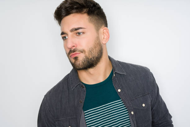 istock Young handsome man possing and modeling over grey isolated background 1127793885