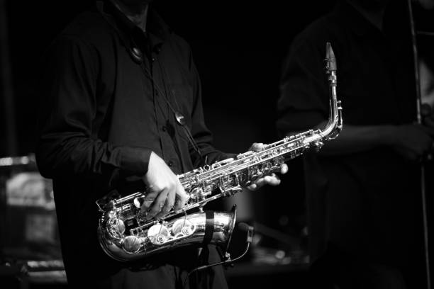 istock Midsection Of Man Playing Saxophone In Darkroom 1127794637
