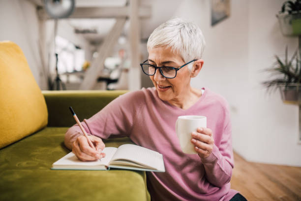 istock Mature woman writing 1127794773