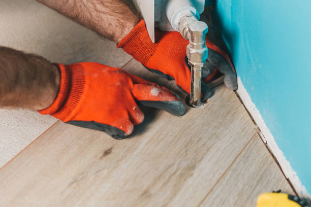 istock How to cut laminate around a heating pipe - master inserts a piece of laminate in place 1127794875