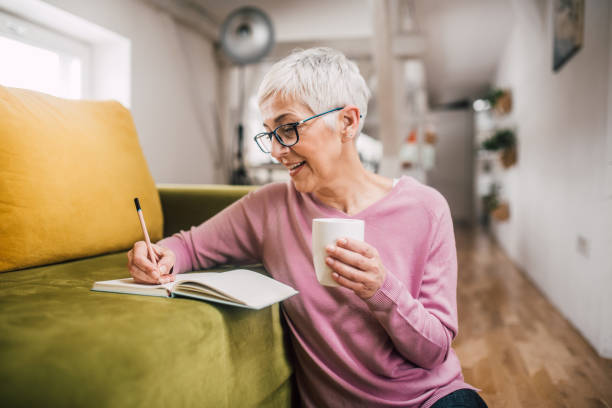 istock Happy woman writing 1127794894