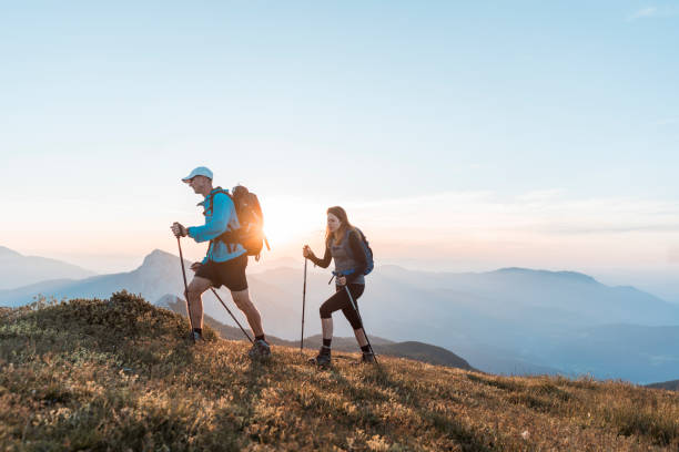 istock Couple hiking in the morning sun 1127795463