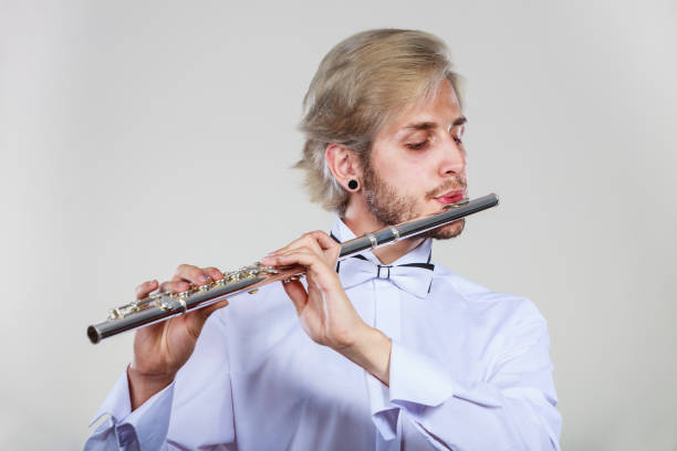 istock Male flutist playing his flute 1127795656