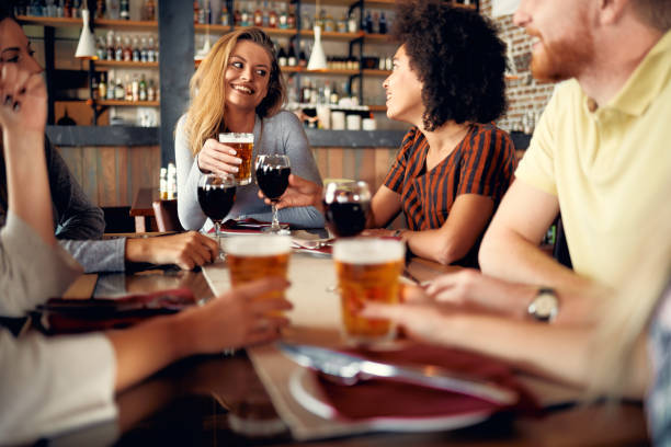 istock Friends sitting in restaurant and drinking wine and beer. 1127795852