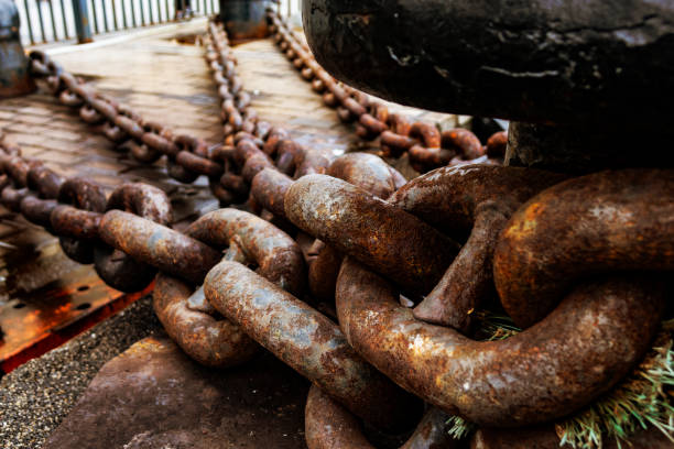 Close up of old rusty chain, industrial port with chains, crane background out of focus, sunny day, industrial concept Anchor Chain, Chain, Link, Freight Transportation, Iron - Metal anchor chain stock pictures, royalty-free photos & images