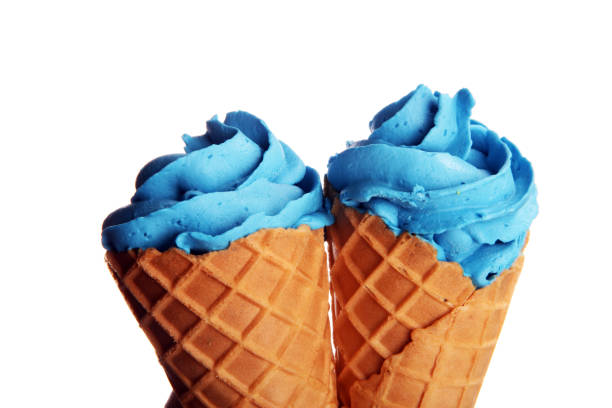 istock Vanilla frozen yogurt or colorful soft ice cream in waffle cone. 1127797158