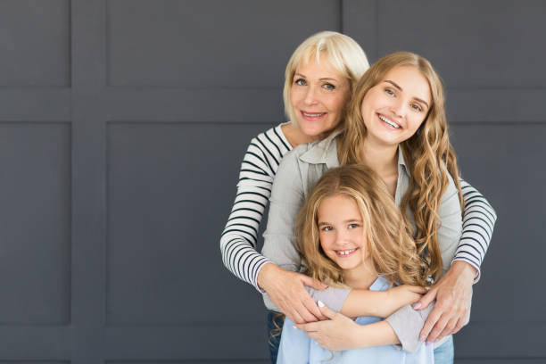 istock Women hugging, looking at camera and smiling 1127798351