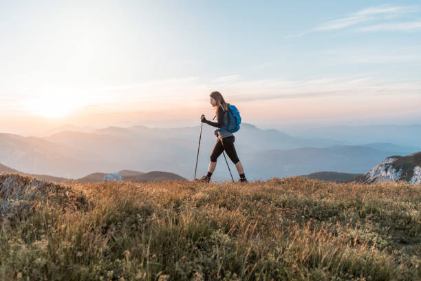 Young women climbing up the hill Young woman with a backpack hiking in the mountains. Exploring in the nature, enjoying the view. slovenia stock pictures, royalty-free photos & images