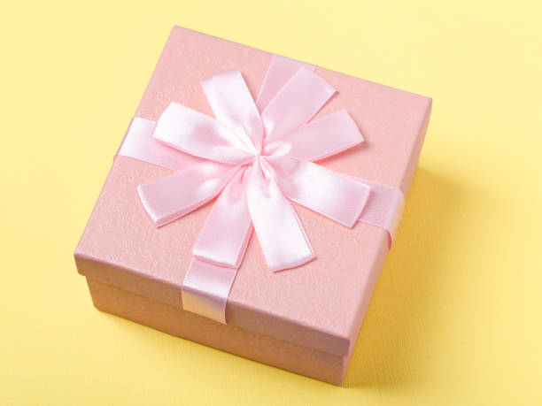 istock Pink gift box with box on yellow background 1127798720