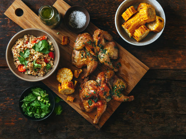 Grilled whole butterflied chickens Grilled whole butterflied chickens with vegetables, chimichurri sauce and quinoa salad chimichurri stock pictures, royalty-free photos & images
