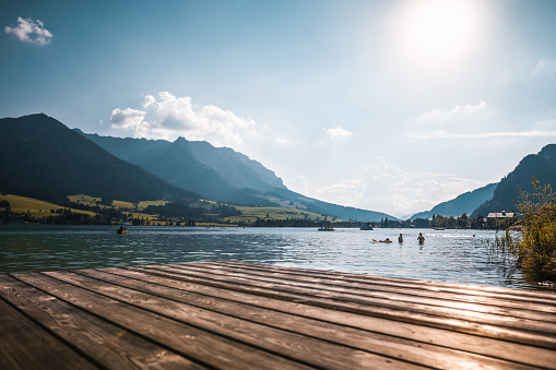 alps panorama on a lake in austria with the mountains in the background in summer on a pier