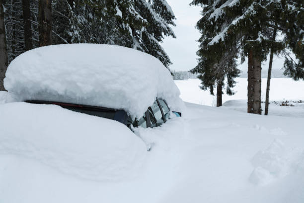 istock One blue car under the driven snow in the mountain among the pine trees. Selective focus 1127807249