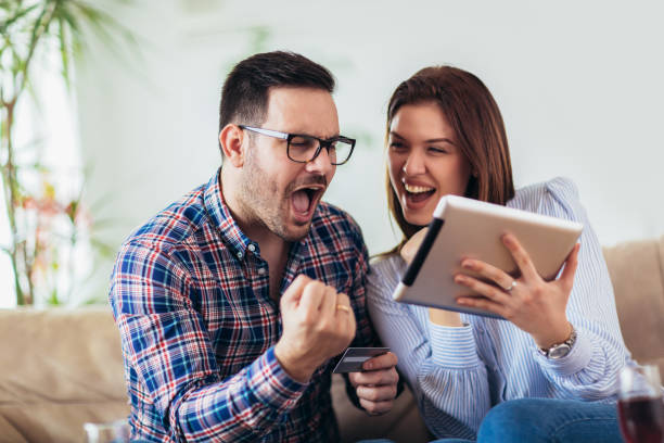 istock Young couple shopping on internet with tablet 1127807704