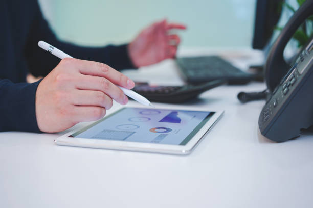 istock close up on businessman manager hand using stylus pen for writing on screen dashboard tablet in video conference meeting situation about company's performance , technology and business strategy concept 1127809362