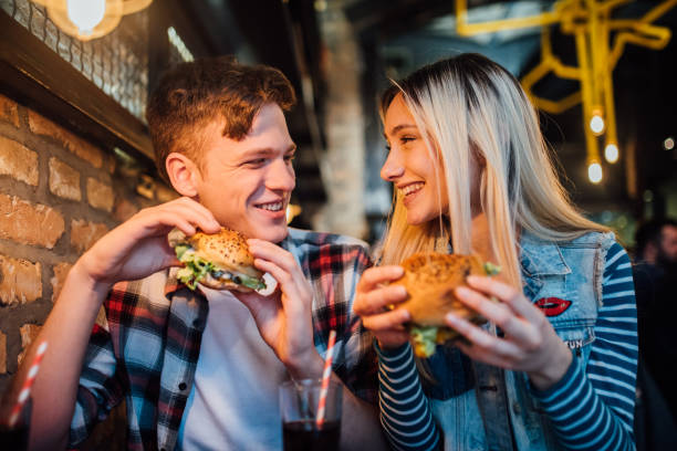 istock Young couple enjoying hamburgers 1127809521
