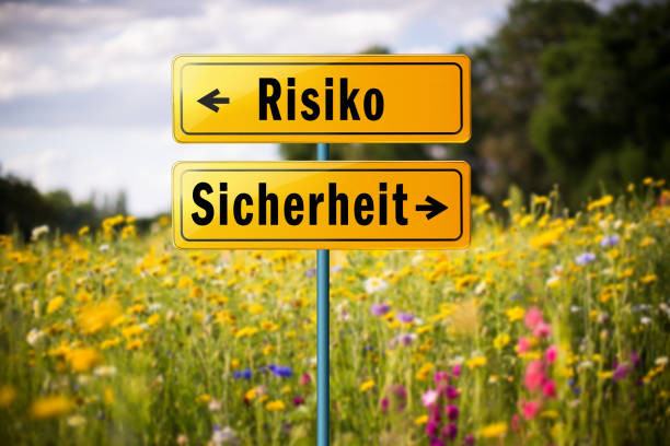 sign with the words "risk" and "safety" in german, pointing in different directions - decisions nature road street imagens e fotografias de stock