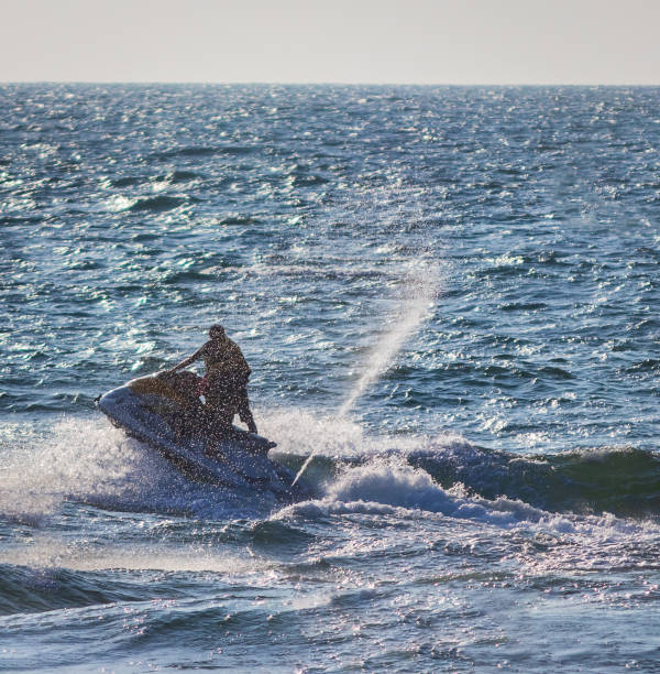 istock Young people  riding a jet ski / wave runner in Goa competing 1127809686