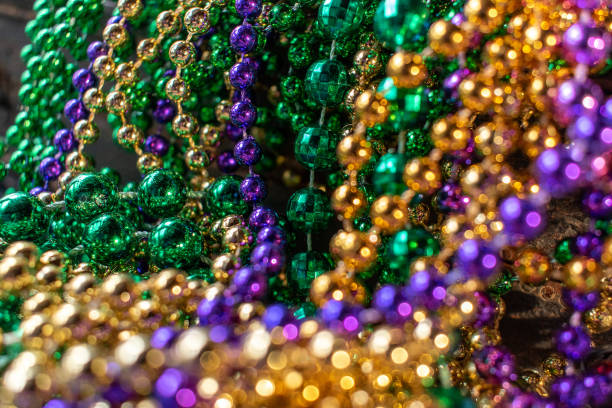 istock mardi gras beads in green, gold, and purple 1127812201