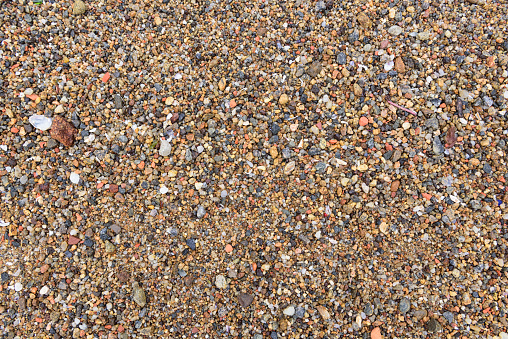 Closeup of pebbles on a beach that can be used as background