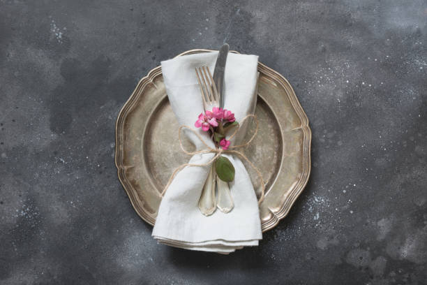 istock Easter romantic dinner. Elegance table setting with spring pink flowers on dark. Top view. 1127813727