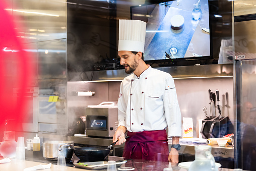 Florence, Italy - August 30, 2018: Kitchen restaurant in Firenze Centrale Mercato central market with cook chef teaching preparing food cooking class