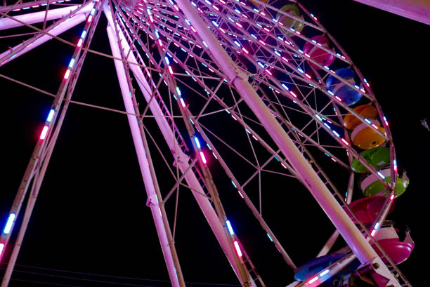istock Colorful Ferris wheel with lights at night 1127815357