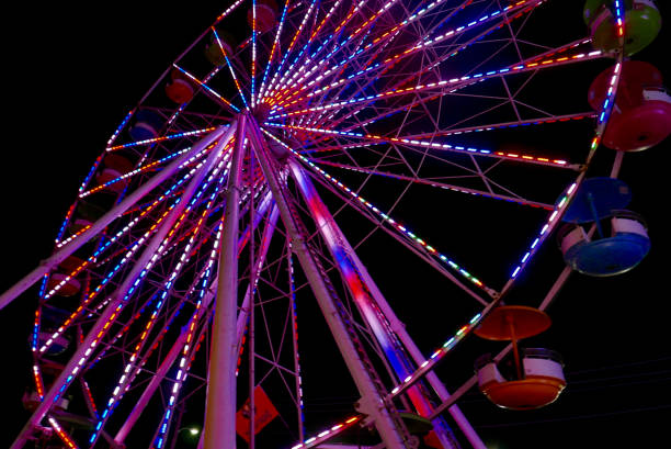 istock Colorful Ferris wheel with lights at night 1127815358