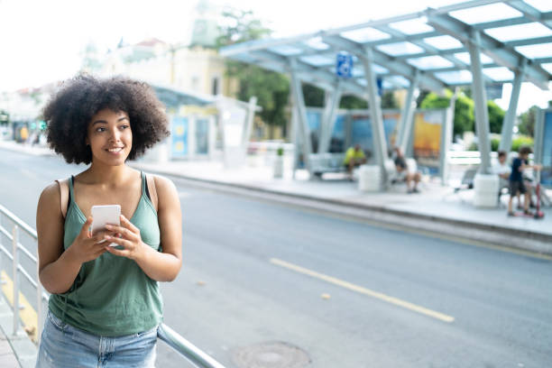 istock African woman with smart phone standing on station 1127816367