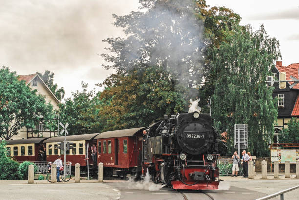Wernigerode, Germany, August 4, 2011 - A train of Harzer Schmalspurbahnen crosses the Westerntorkreuzung in Wernigerode.