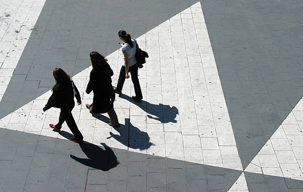 Three young women crossing Sergels Torg in Stockholm stock photo