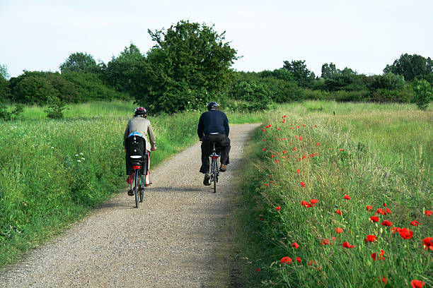 istock Parents biking in park with a child on the back. 112782093