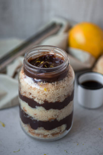 Cake in a jar Lemon cake in a jar layered with chocolate ganache cake jar stock pictures, royalty-free photos & images