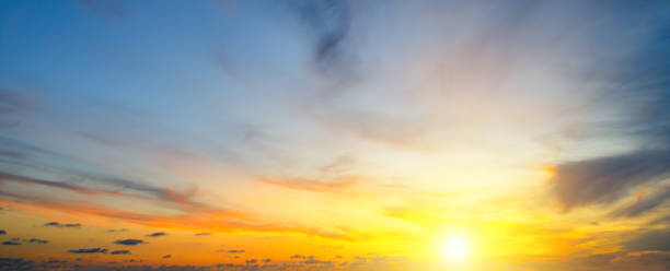 istock Cloudy sky and bright sun rise over the horizon. 1127824330